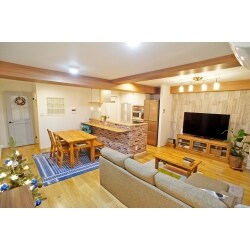 和室部分を取り込んで、大きなLDKとしました。吊戸を設けずコンロ側の壁に寄せたペニンシュラタイプの対面キッチンは２方向にオープンしているため、食事も、リビングでのティータイムにもアクセスしやすく家事もスムーズ。縦横に走る梁を木目に化粧することで左右、前後にに視線を誘導し、広くなった空間の上からの圧迫感を解消しています。