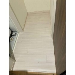 現地調査を行ったところ、洗濯機置き場の床には黒ずみがあり、洗濯排水トラップの金属カバーには黒ずみや汚れがみられました。
原因を追求すると、排水トラップのカバー周りから水漏れしていることが判明。洗濯機を移動させてみると、水漏れによるシミは奥にまで広がっていました。
そこで、排水トラップの交換と床を新しくクッションフロアで上張りする工事をご提案させていただき排水トラップの交換については、通常は床上からできますが、お客様宅はフローリング面に糊付けされてしまっていたため、フローリングに専用のこぎりで穴を開け、床下からの交換作業を行いました。