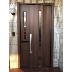 ドアノブが壊れた為、これを機に玄関ドアを新しく取り替えしたいとのご相談を頂きました。既設の玄関ドアは、親子扉でポスト付き。機能やイメージはそのままで、最新型に交換ご希望とのことでしたので、お打合せもスムーズに進みました。鍵は、リモコンキーをバッグやポケットに入れておけば、ドアのボタンを押すだけで解錠できる、タッチキー（キー付きリモコンタイプ）。とても便利で、防犯性アップ。欄間をなくし、扉を大きくしましたが、採光部のある扉をお選び頂きましたので、玄関も明るく保つことができました。