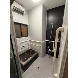 浮いているタイルを丁寧に剥離した後、浴室用のパネルとシートを用いてユニットバス風にリフォームしました。元の浴室の形に合わせ、壁にはパネルを、床にはシートを施工いたしました。水栓面にはアクセントとして石目柄を採用し、デザイン性にもこだわった仕上がりとなりました。浴室の広さはそのままに、安心して入浴できるユニットバス風の浴室に生まれ変わりお客様にも大満足いただきました。