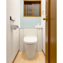 トイレを収納棚付きへリフォーム希望の施主様。
収納棚付のLIXILリフォレをご提案。
白く輝くトイレが引き立つようにストライプのクロスに青色のアクセントクロスで清潔感と高級感を演出。
タイルは剥がさず床の上に合板を上貼り。コストを抑えつつとてもオシャレなトイレ空間になりました。