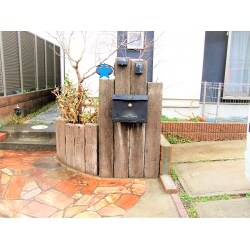 ポストやインターホンが取り付けてある「枕木」を交換しました。
雨風を受け、経年劣化により、腐ってしまっていました。
又、駐車スペース奥へは、シルバーの開閉可能なフェンスを新設しています。