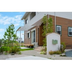 住宅のナチュラルテイストに合うように、程よく曲線を用いた外構へと仕上げました。土間にも緩やかな曲線を用いることで、優しい印象になります。目地にはアクセントでタマリュウを入れることで動きを強調。庭のテラス屋根は日常の洗濯物はもちろん、自転車も止めやすくするために、ウッドデッキはあえて出幅を出していません。小さな子供たちがお庭で遊び、親がデッキに腰かけて見守る。ちょうどいいサイズです。