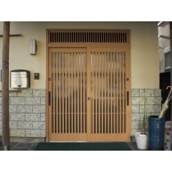 ガラス面が大きな木製の引き戸から、細かいたて格子のアルミ製引き戸に取り替え。
ナチュラルなカラーで、家の顔である玄関が明るくなりました。

