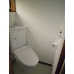 元々和式トイレで部屋が狭く、通常のトイレが取付け出来ないため、タンクの形が三角形のコンパクトタイプのトイレを斜めに取付けしました。
床もフラットになりクッションフロア仕上げで壁と天井もクロス仕上げにしてトイレが明るくなりました。