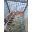 ガラスブロックとアルミフロントサッシで囲まれた階段室、タモ集成の木質感とFRPグレーチングの無機質な感じが相まって透明感あふれる中にも温かみを感じさせます。