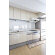 床の木目に合わせて、明るいパネルのキッチンに。標準的な価格帯でも、機能や品質が優れたトクラスのキッチンをセレクト。サイズも変更して、冷蔵庫をすぐ横に置けるように設計しました。