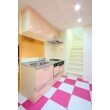 キッチンはピンクとホワイトのフロアタイルを市松模様に貼り分け、キッチンの面材も上品なピンクで統一し、明るく華やかな空間に仕立てました。壁付から対面式のキッチンに変更したことで、視界も広がり、リビングとの会話も楽しめます。