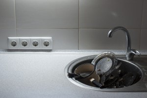 Kitchen with piles of dirty dishes