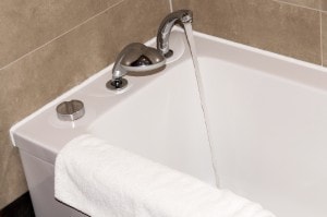 white bathtub in the bathroom with a towel