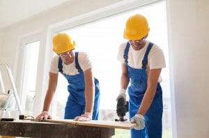 group of builders with tools indoors