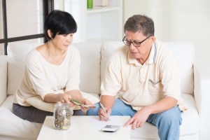 asian senior couple calculating finance at their home