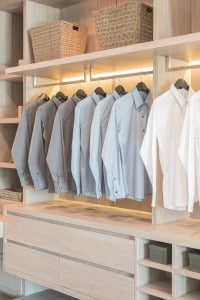 row of shirts hanging on rail