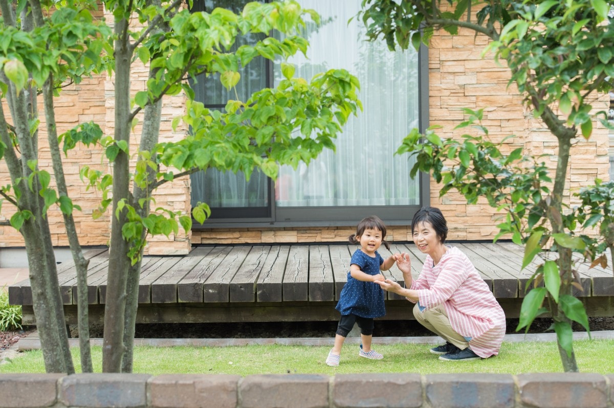 庭で遊ぶ母と子